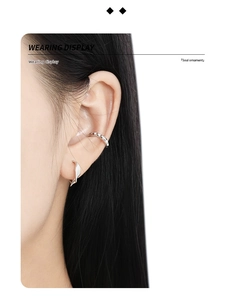 Close-up of minimalist S925 sterling silver ear cuff and irregular twisted stud earring