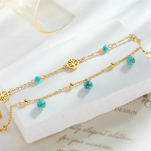 Gold double-layer anklet with turquoise beads and a tree of life pendant on stone