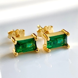 Macro shot of S925 sterling silver stamp and emerald green rectangular zircon stud earrings