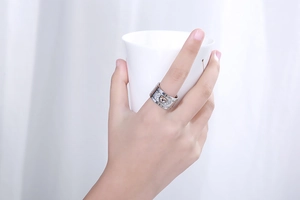 Close-up of model wearing a wide silver steel ring with a champagne crystal on a hand