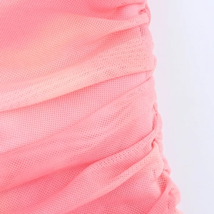 Gros plan sur le tissu en maille rose avec texture froncée et design plissé doux