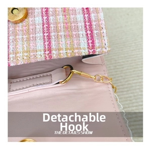 Detail of detachable gold hook and pink tweed texture on girls crossbody bag