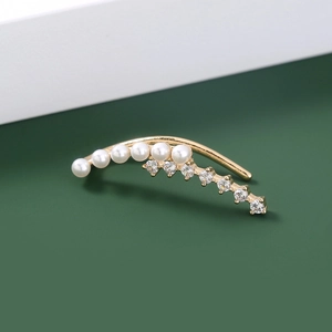 Detailed view of a gold star ear cuff featuring sparkling rhinestones and small pearls