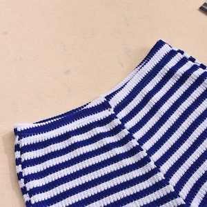 Close-up of blue and white striped knit texture on high-waist summer shorts