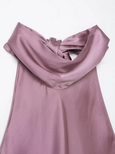 Close-up of pink satin halter neck top with elegant back tie knot detail