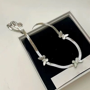 Silver stainless steel snake chain necklace with butterfly accents in a jewelry box