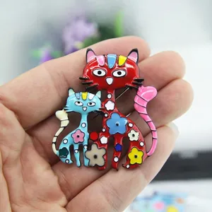 Charming enamel cat brooch featuring colorful floral details on gold-plated metal alloy