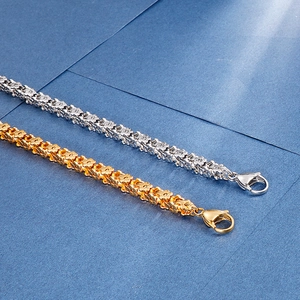 Detailed shot of flower chain link bracelets in gold and silver steel with lobster clasp
