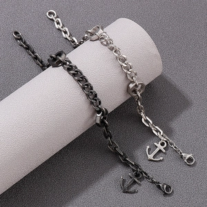Men's anchor chain bracelet in silver and gunmetal finish on minimalist display