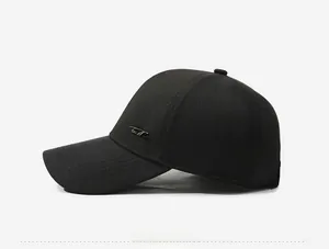 Side view of black baseball cap with fine texture and decorative metal script logo