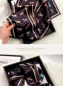 Detail of equestrian silk scarf with horse print in a luxury gift box presentation