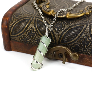 Natural hexagonal green crystal pendant with silver spiral wire wrap on vintage box