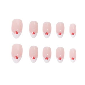 French tip press on nails with red heart accent and elegant oval shape in nude pink