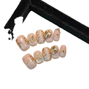 Handmade nude pink press-on nails set with champagne cat-eye glitter and gold butterfly
