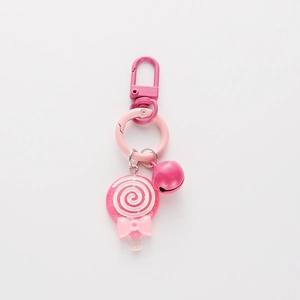 Pink lollipop keychain with spiral candy pendant, metal bell, and cute bow charm