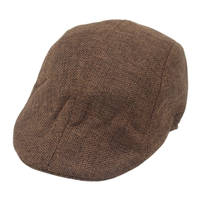 Detailed close-up of dark brown newsboy cap showing rustic woven fabric texture