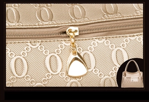 Detailed macro view of champagne gold handbag with textured relief and metal zipper