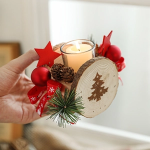 Hand holding a wooden Christmas candle holder with pine cones and red star decor