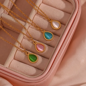 Detailed shot of waterdrop opal pendants in multiple colors with gold stainless steel chains