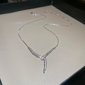 Detailed view of silver snake-style V-shaped necklace with micro-pave cubic zirconia crystals
