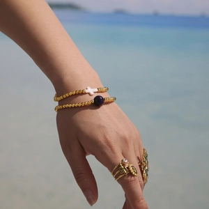 Handmade 18K gold-plated beaded bracelet set with cross and purple charms by the sea