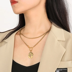 Detail of model wearing a double-layer golden Tree of Life pendant with Cuban chain