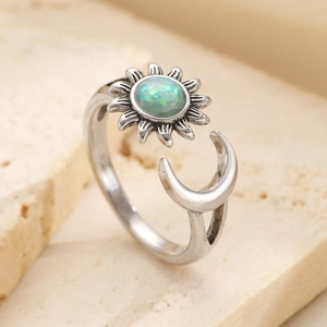 Vintage sun and moon open ring featuring an iridescent opal stone in a silver finish