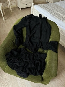 Detail view of black lace lantern sleeve top and layered ruffle cake skirt set