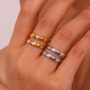 Double-layered 18K gold and silver stainless steel cross rings shown on hand