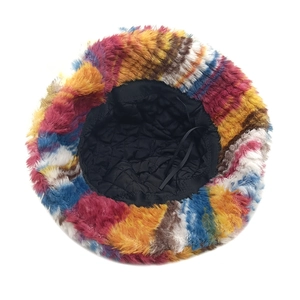 Detail of colorful striped plush bucket hat showing quilted lining and adjustable strap
