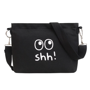 Casual black canvas shoulder bag with white shh! cartoon face print on a white background