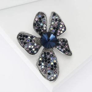 Elegant vintage flower brooch with deep blue rhinestones and crystal flower petals