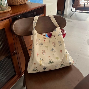Detailed close-up of a floral cotton tote bag with a Simple Wish fabric label