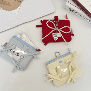 Bow card holder pouch with pearl charm and heart pendant in red, blue, and yellow