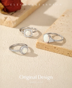 Three elegant S925 sterling silver rings with opal stones and small crystals on a stone base