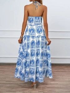 Detail showing the backless halter design and tropical blue palm print on the maxi dress