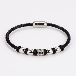 Detailed macro view of woven black leather bracelet with silver beads and black zircon