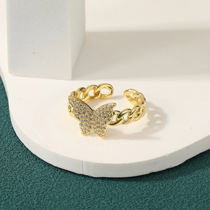 Detail of 18K gold-plated Cuban chain ring with sparkling pavé butterfly accent