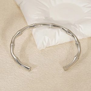 Macro shot of silver bamboo joint open bangle bracelet with a polished metallic finish