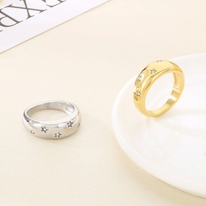 Detailed macro view of dome rings featuring star patterns with embedded sparkling rhinestones
