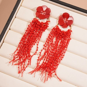 Detail view of red floral glass beaded fringe earrings with matte finish flower petals
