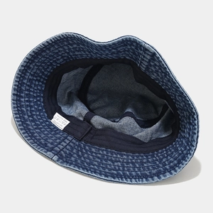 Deep blue washed denim bucket hat with internal cotton lining and woven label