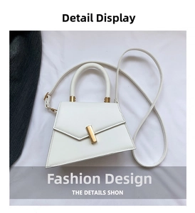 Detail of white geometric PU handbag with golden metal clasp and curved top handle