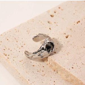 Detailed macro shot of silver lava texture ring featuring a centered black gemstone