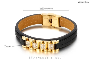 Detail of black leather bracelet with golden stainless steel links and zircon inlays
