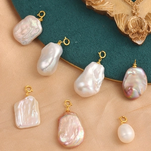Elegant natural baroque pearl pendants with gold S925 silver clasps on silk background