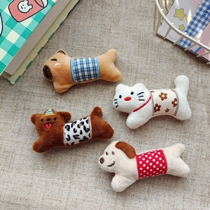 Detailed view of plush animal brooches with floral, plaid, and leopard patterns