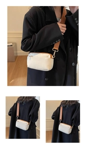 Three-view display of beige canvas crossbody bag with brown leather trim and wide strap