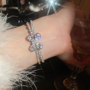 Macro view of crystal butterfly bracelet with pear-shaped stones and pearl center