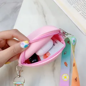 Detail view of pink silicone mini coin purse with rainbow lanyard and zipper closure